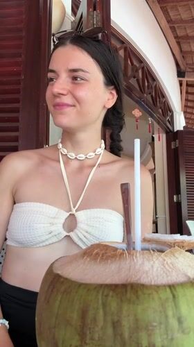 Family enjoys beachfront meal and coconuts in Vietnam resort