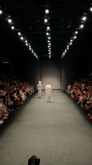 Fashion show features models in silver and mauve suits