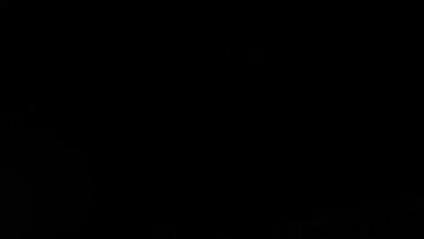 This media file is a short video that appears to be captured on a mobile device. The initial frames are completely black, suggesting a potential issue with recording or playback initialization. As the video progresses, the image brightens, revealing a dark environment with a hint of green light emanating from the bottom right of the frame. This green light appears to be originating from a small, rectangular object with a visible cable extending from its side. The object itself is difficult to discern clearly due to the low light conditions.

The scene is dark, making it challenging to identify any specific objects or the overall setting. There are no discernible people or animals present in the visible portion of the media. The ambient sound, as suggested by the timestamp, is silent. The time of day cannot be determined, nor can any weather conditions or specific location cues within Harlingen, Netherlands, be inferred. The overall mood conveyed by the dark and indistinct visuals is one of mystery or perhaps an incomplete recording. No visible text is present in the media.
