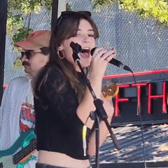 Live outdoor band performance with vocalist and full lineup