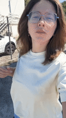 Woman takes selfie video while walking in sunny Podgorica