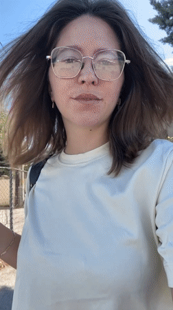 Woman takes selfie video while walking in sunny Podgorica