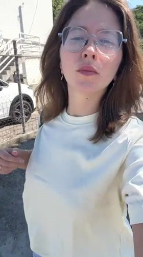 Woman takes selfie video while walking in sunny Podgorica
