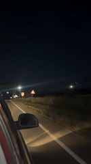 Nighttime road trip, streetlights and stars overhead