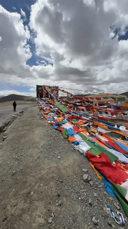 Visitors interact with Tibetan prayer flags in Hor town