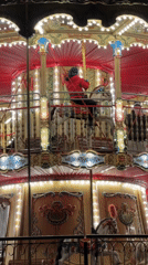 Evening scenes captured around illuminated carousel in Gdańsk