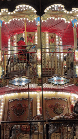 Evening scenes captured around illuminated carousel in Gdańsk