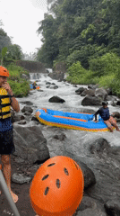 White water raft gets stuck on rocky Indonesian river
