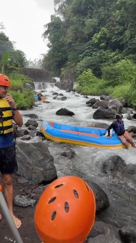 White water raft gets stuck on rocky Indonesian river