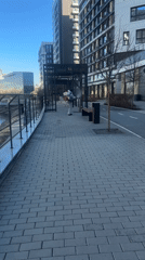 Worker in hazmat suit sprays walkway near Yekaterinburg waterway
