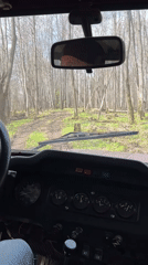 Vehicle drives through spring forest near Zhigalki, Russia
