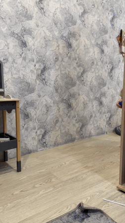 Toddler plays with pogo stick indoors in Rusanovo