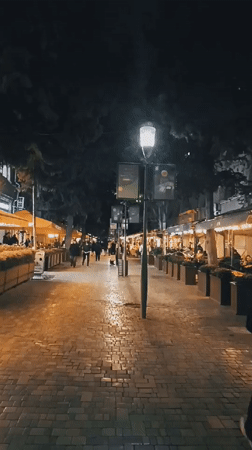 Evening street life documented around SuperStep store in Baku