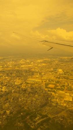Aerial views over Dar es Salaam through a cabin window