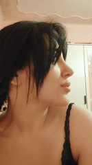Woman in black tank top observed looking upward in Yerevan room