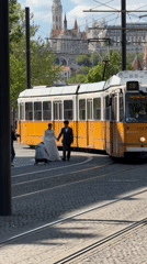 Wedding photoshoot takes place on Budapest street with tram rails