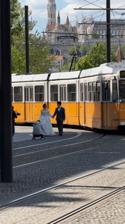 Wedding photoshoot takes place on Budapest street with tram rails