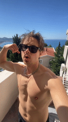 Young man films selfie video on Montenegro balcony