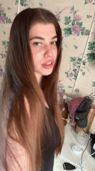 Woman records selfies in floral-wallpapered room in Russia