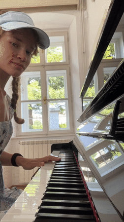 Woman plays piano, takes selfies in Cetinje music room