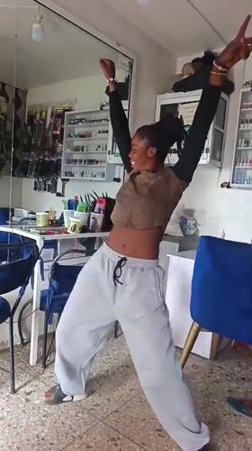 Candid moment dancing inside a salon or beauty store
