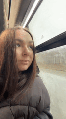 Woman rides bus on rainy morning in Krasnokamsk