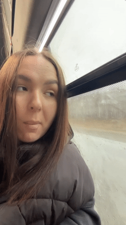 Woman rides bus on rainy morning in Krasnokamsk