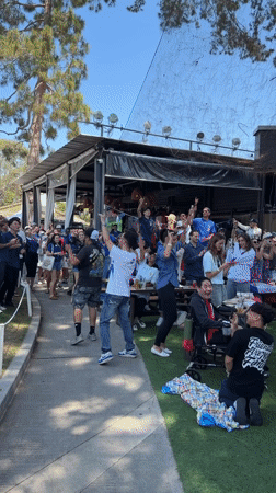 Crowd cheering at an outdoor celebration in Los Angeles