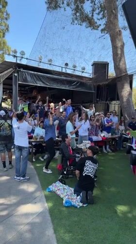 Crowd cheering at an outdoor celebration in Los Angeles