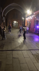 Evening street life documented in Moscow with dining, bubbles