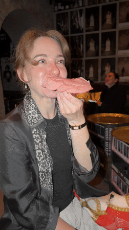 Woman eats bologna sandwich at Moscow restaurant