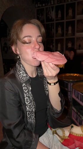 Woman eats bologna sandwich at Moscow restaurant