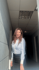 Woman in business attire observed in hallway