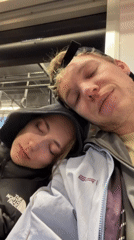 Woman sleeps on companion's shoulder during train ride