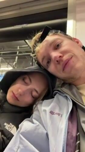 Woman sleeps on companion's shoulder during train ride