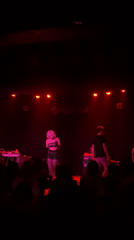 Late-night concert performance captured at Barcelona venue with red lighting
