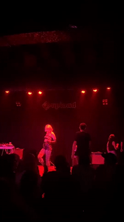 Late-night concert performance captured at Barcelona venue with red lighting