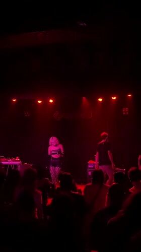 Late-night concert performance captured at Barcelona venue with red lighting