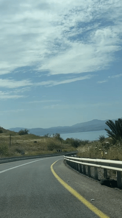Car travels mountain road in Golan Heights region