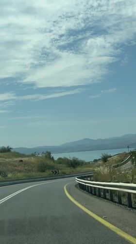 Car travels mountain road in Golan Heights region