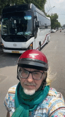 Scooter passenger spotted in red helmet on Thuận An street