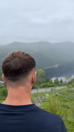Man observes distant landscape in Dalen, Norway