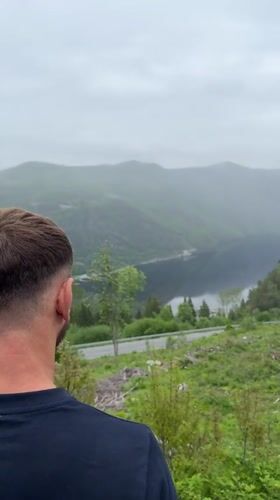 Man observes distant landscape in Dalen, Norway