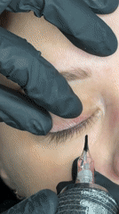 Beauty professional applies permanent eyeliner procedure in Riga