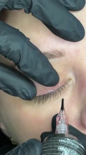 Beauty professional applies permanent eyeliner procedure in Riga