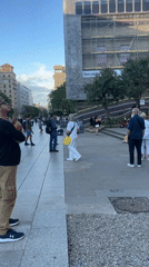 Pedestrians walk through Barcelona public square on Thursday afternoon