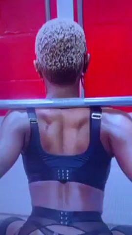 The video shows a series of close-up shots of people in lingerie and swimwear. The first shot is from the back of a person squatting with a barbell. They are wearing a black sports bra and matching bottom with suspender straps. The next shot shows a person in a dark blue bodysuit with a silver emblem on the belt. The following shot shows a person in red lingerie with white lace. The last shot is of a person in a black lace top that exposes their chest. The background of each shot is blurred.