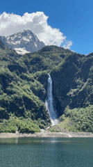 Hiker visits scenic Lac d'Oô waterfall in French Pyrenees