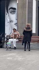 Sailor-costumed accordionist performs on Las Palmas pedestrian street