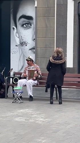 Sailor-costumed accordionist performs on Las Palmas pedestrian street